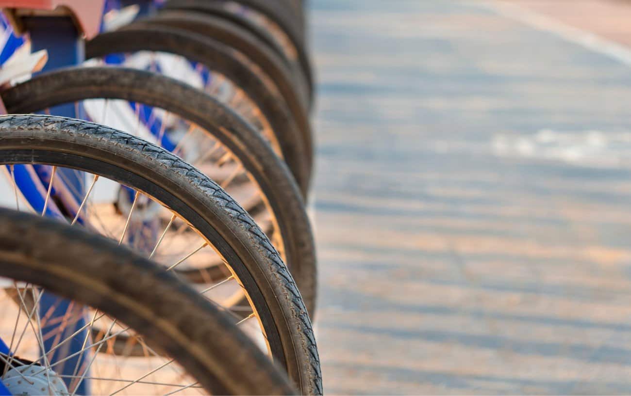 A row of bike wheelsets with the tires in focus.