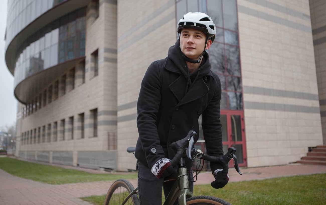 A cyclist rides his winter bike through a university.