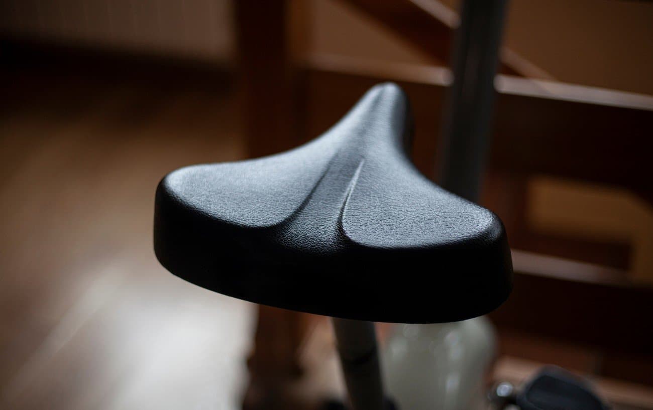 A black bike saddle on an indoor bike.