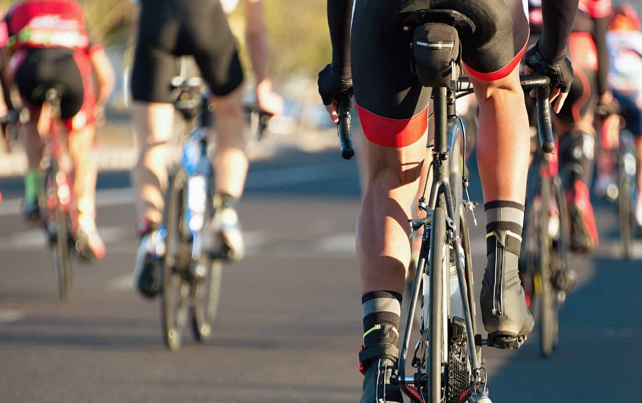A group of cyclists riding road bikes on a tarmac surface.