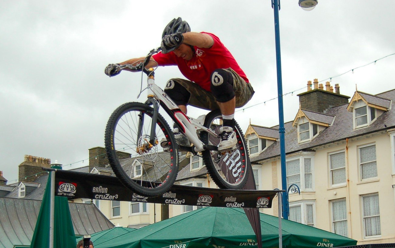 Martyn Ashton performs bike stunts on a beam.