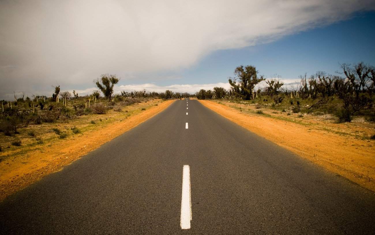 View down a tarmac road in the Australian Outback.