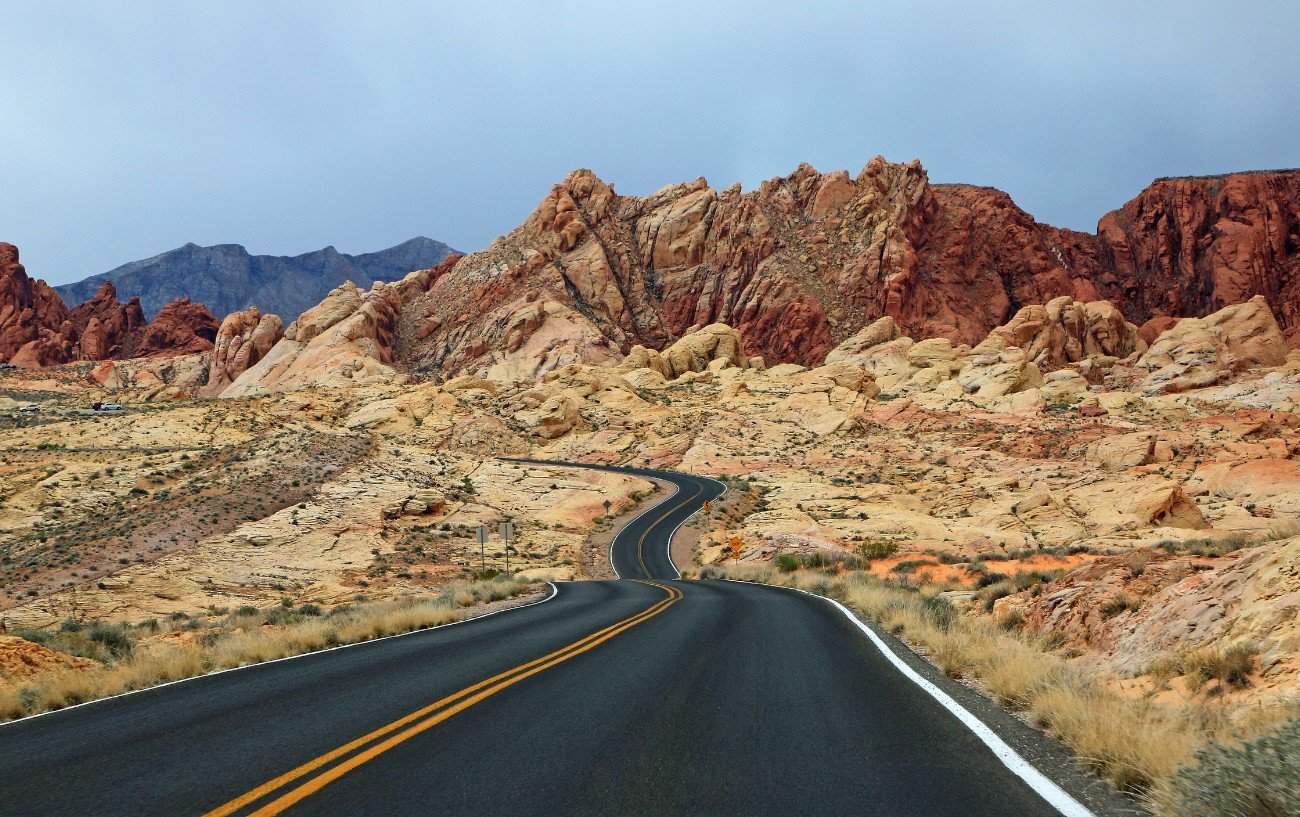A tarmac road snakes through the jagged, Martian landscape of Utah.