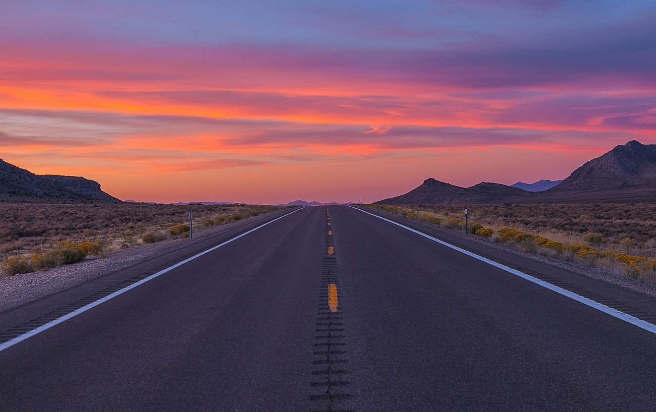 Late sunset sky over a tarmac road in Nevada.