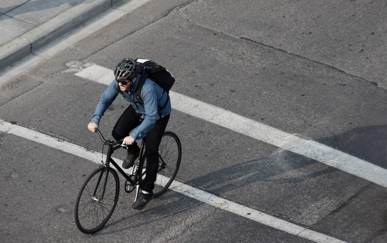 A commuter rides a hybrid bike through the city.