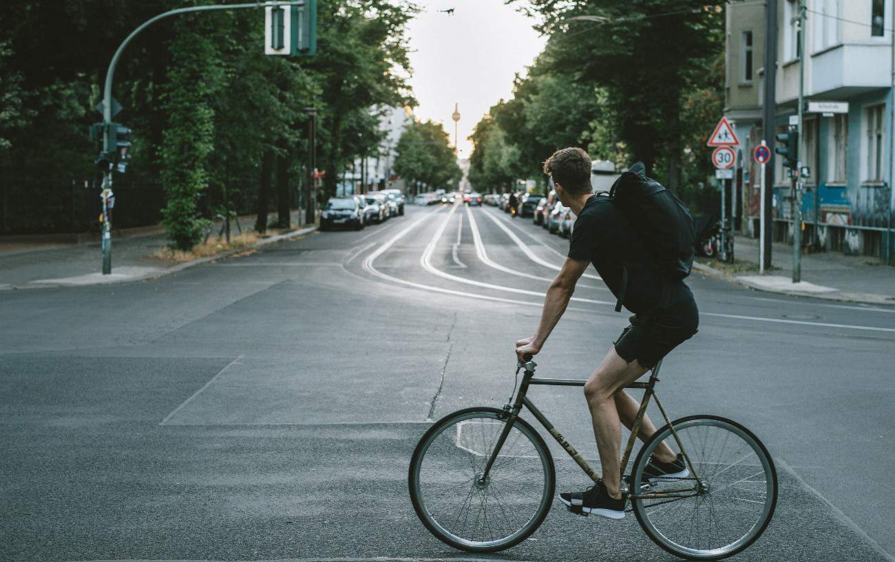 A commuter on a single-speed bike rides through the streets of Berlin.