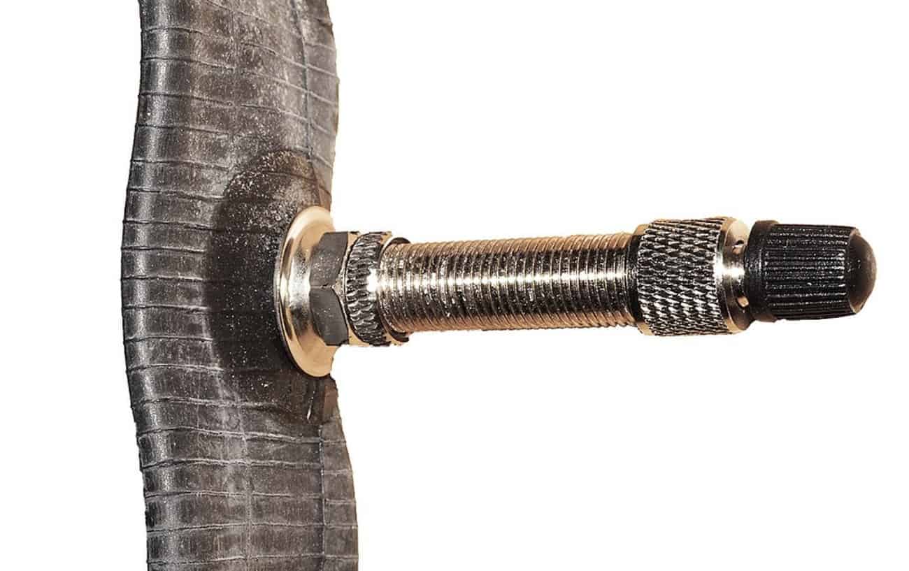 Dunlop valve on an inner tube, with the bicycle tire valve caps attached.