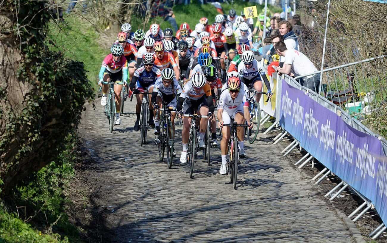 The peloton takes on a cobbled pavé climb at the women's Tour of Flanders.