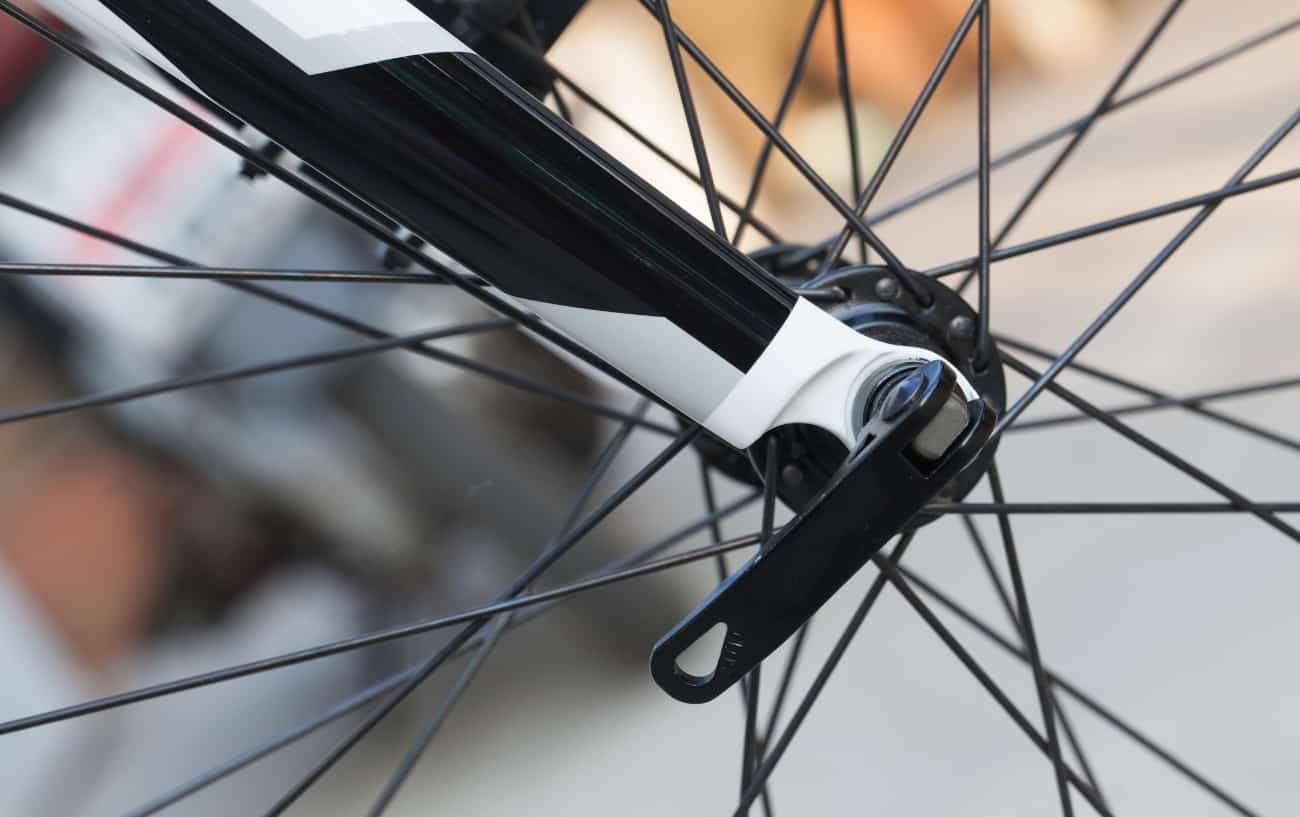 Photo of a black quick release bike wheel on a road bike.
