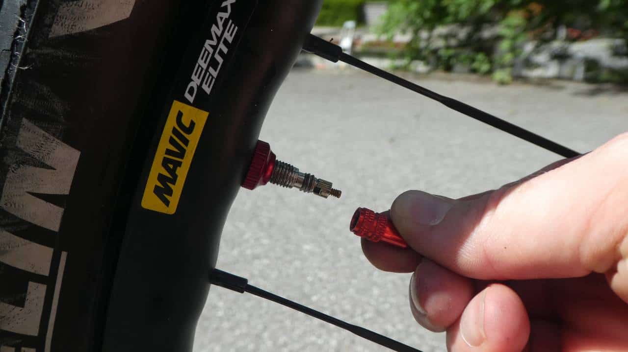 Removing a dust cap from a mountain bike tire