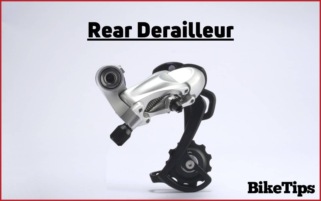 Photo of a rear bike derailleur against a grey background.