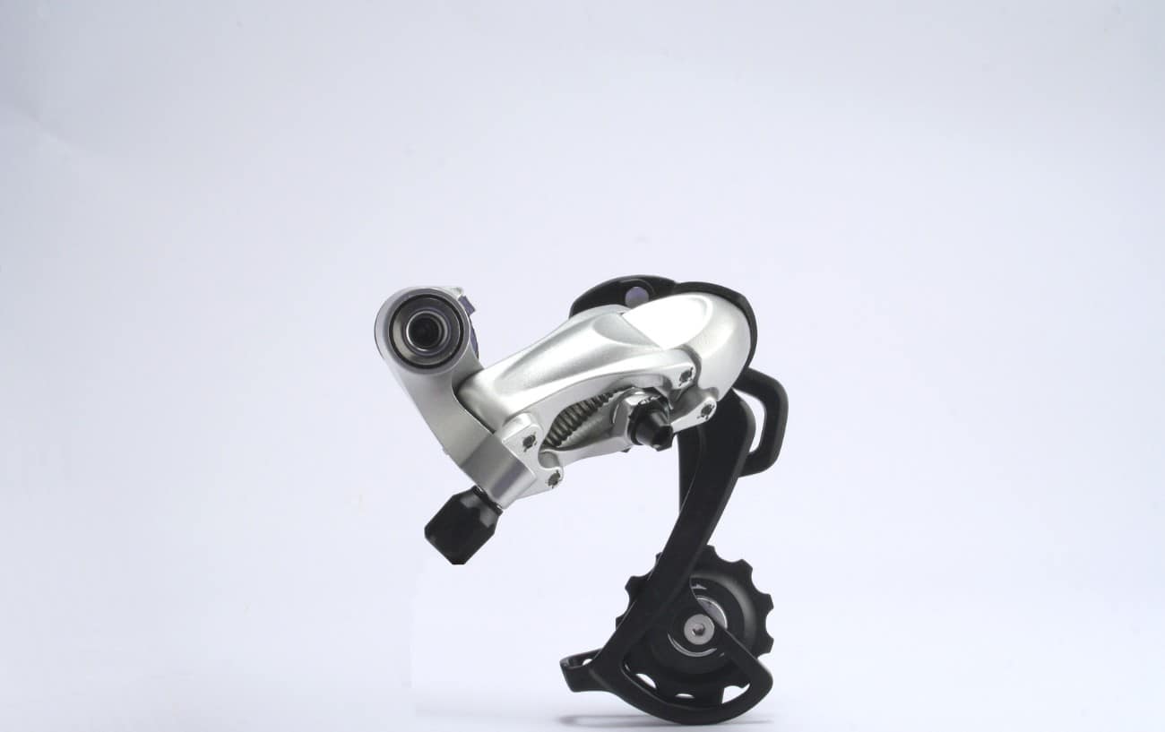 Photo of a silver rear derailleur against a white background.