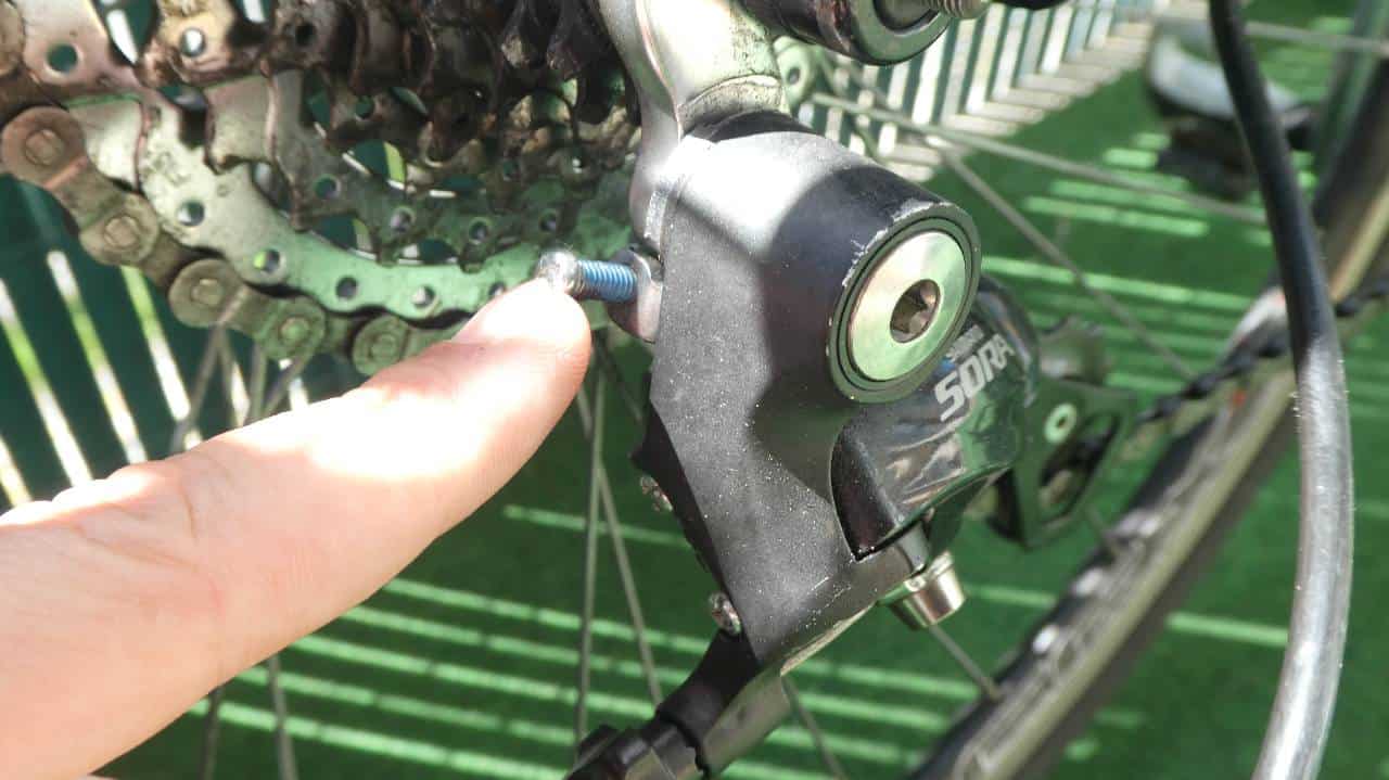 Pointing out the "B" screw on a rear bike derailleur.