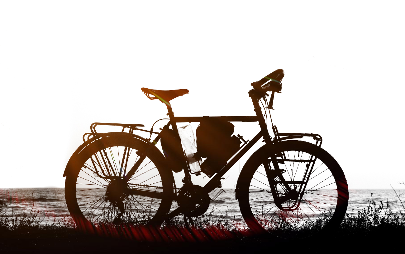 Silhouette of a touring bike at the beach.