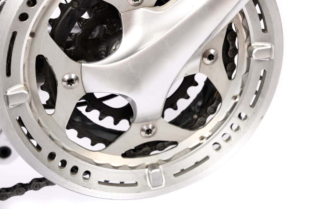 Close-up of a triple chainring against a white background.