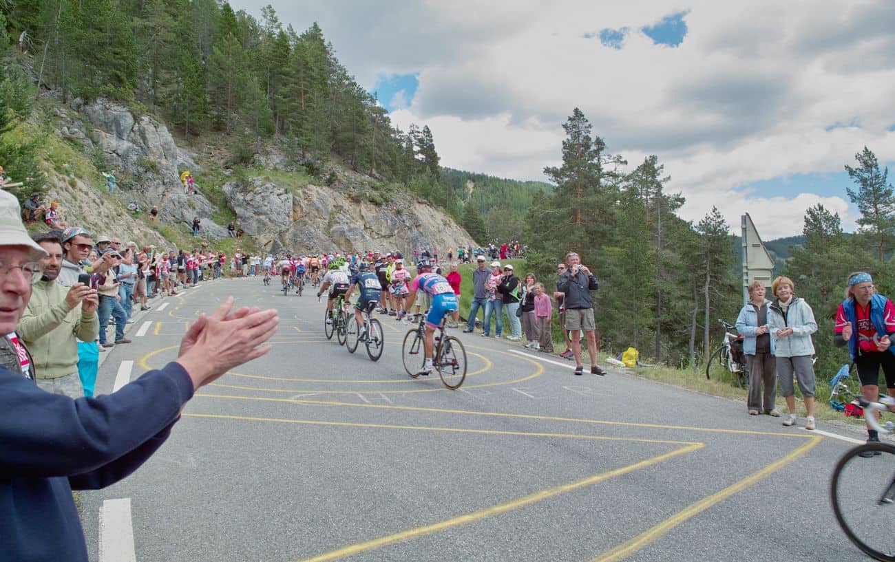 A pack of cyclists climb a mountain in the Tour de France.