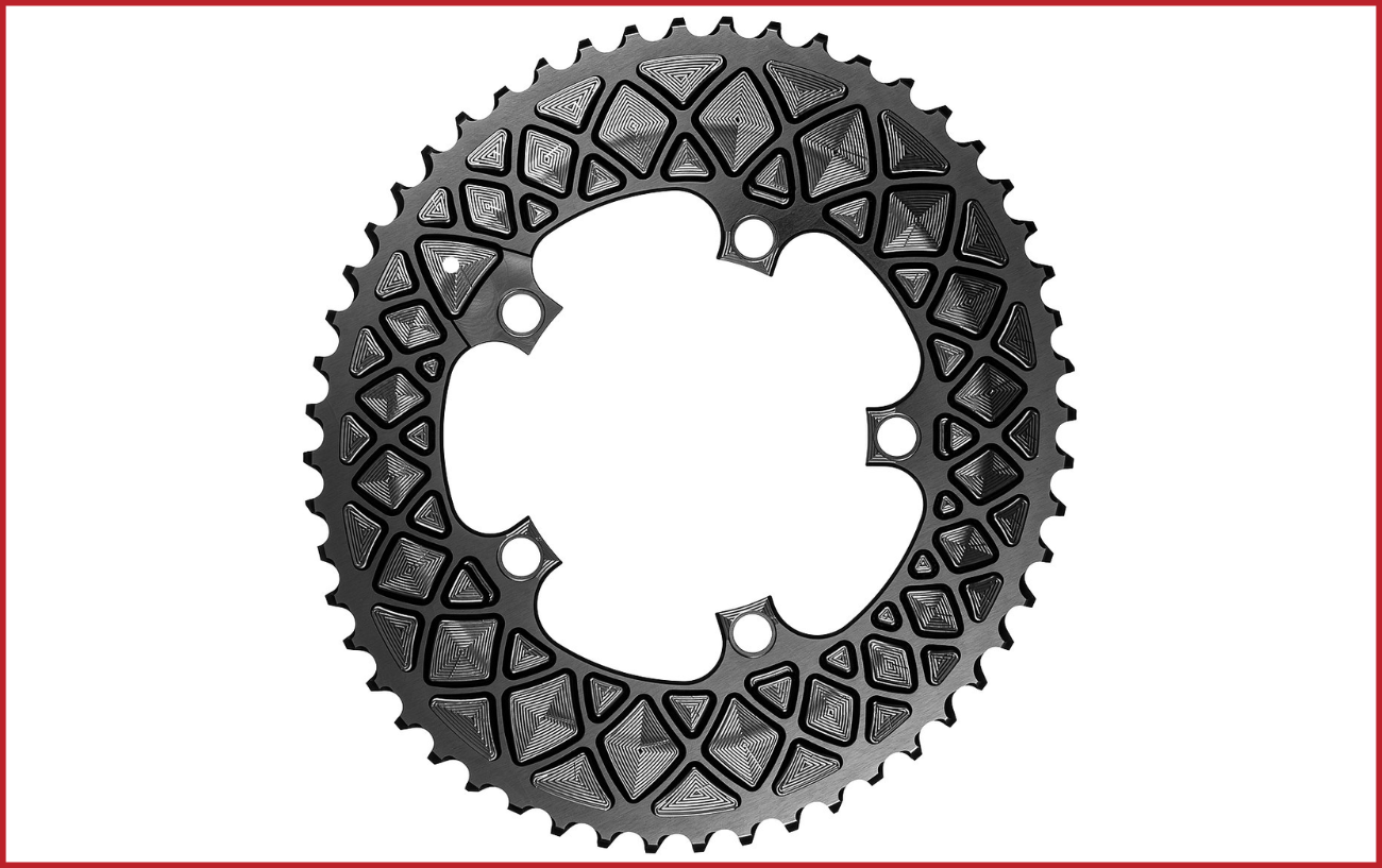 Close-up of a black oval chainring photographed against a white backdrop.