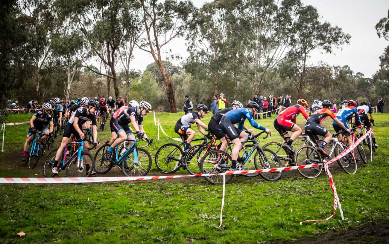 A cyclocross race hurtling around a bend.