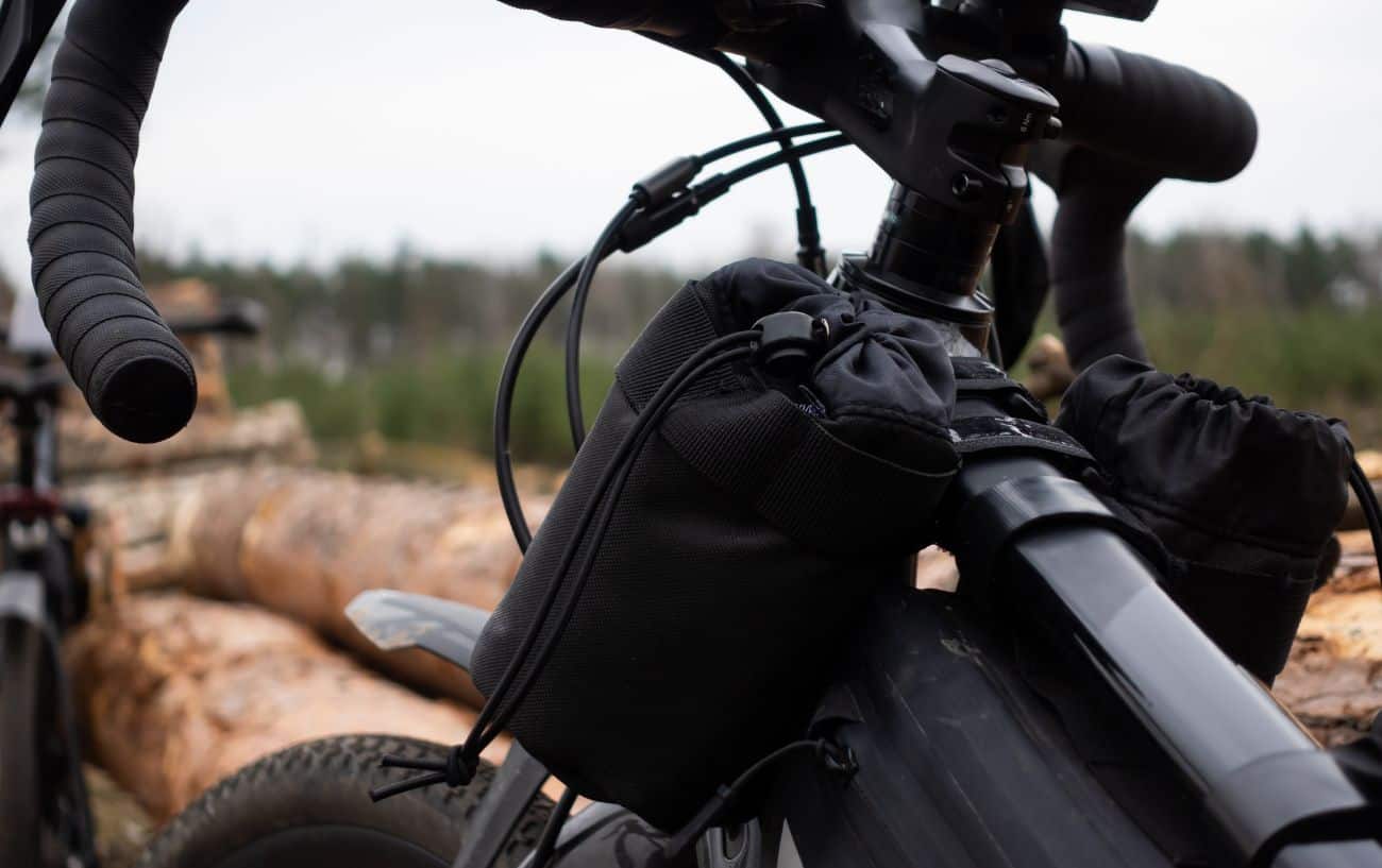 Close-up of the cockpit of a gravel bike with bikepacking bags.
