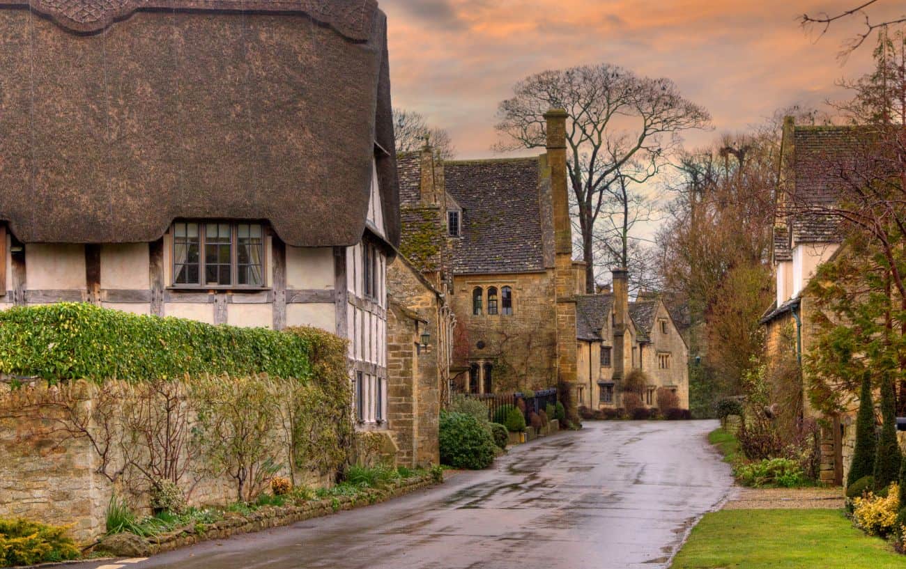 A country road snakes through a medieval village in Gloucestershire.