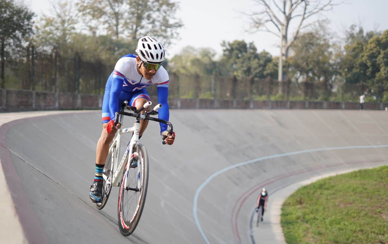 A cyclist riding at an outdoor velodrome takes it easy during a polarized cardio session.