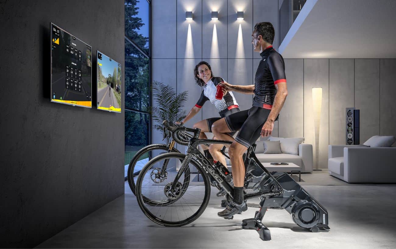 Two cyclists ride Rouvy bikes: Manufacturer Image
