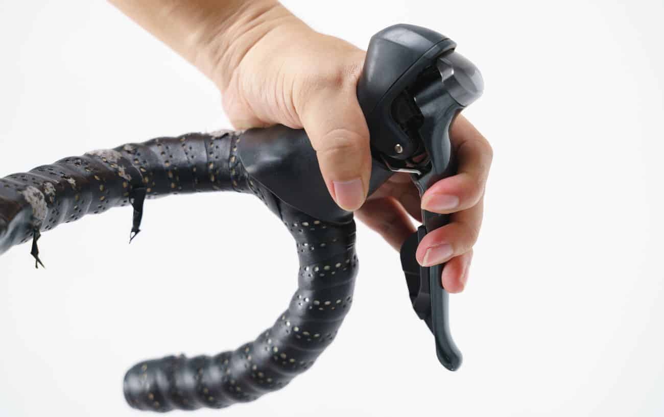 Black road bike shifters against a white background.