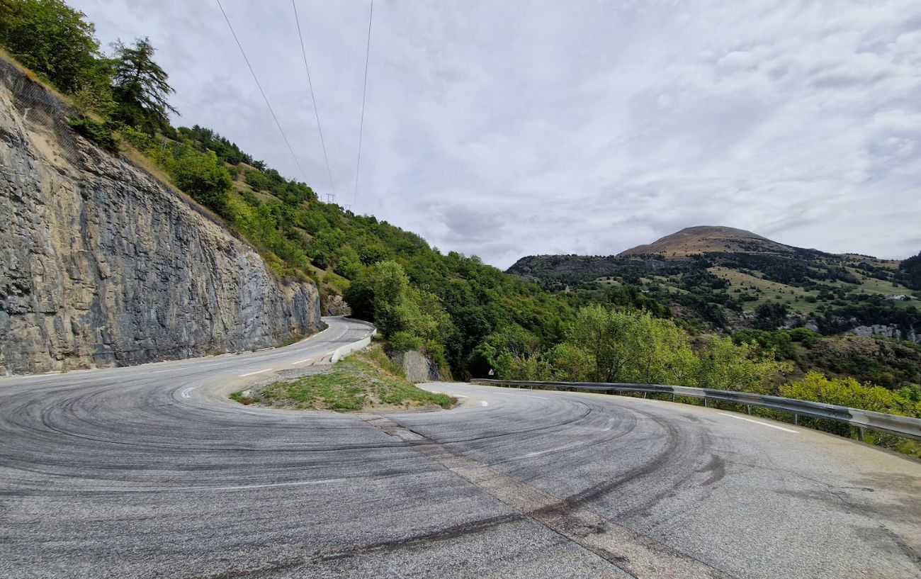View of one of the sharp asphalt hairpins on the road to Alpe d'Huez.