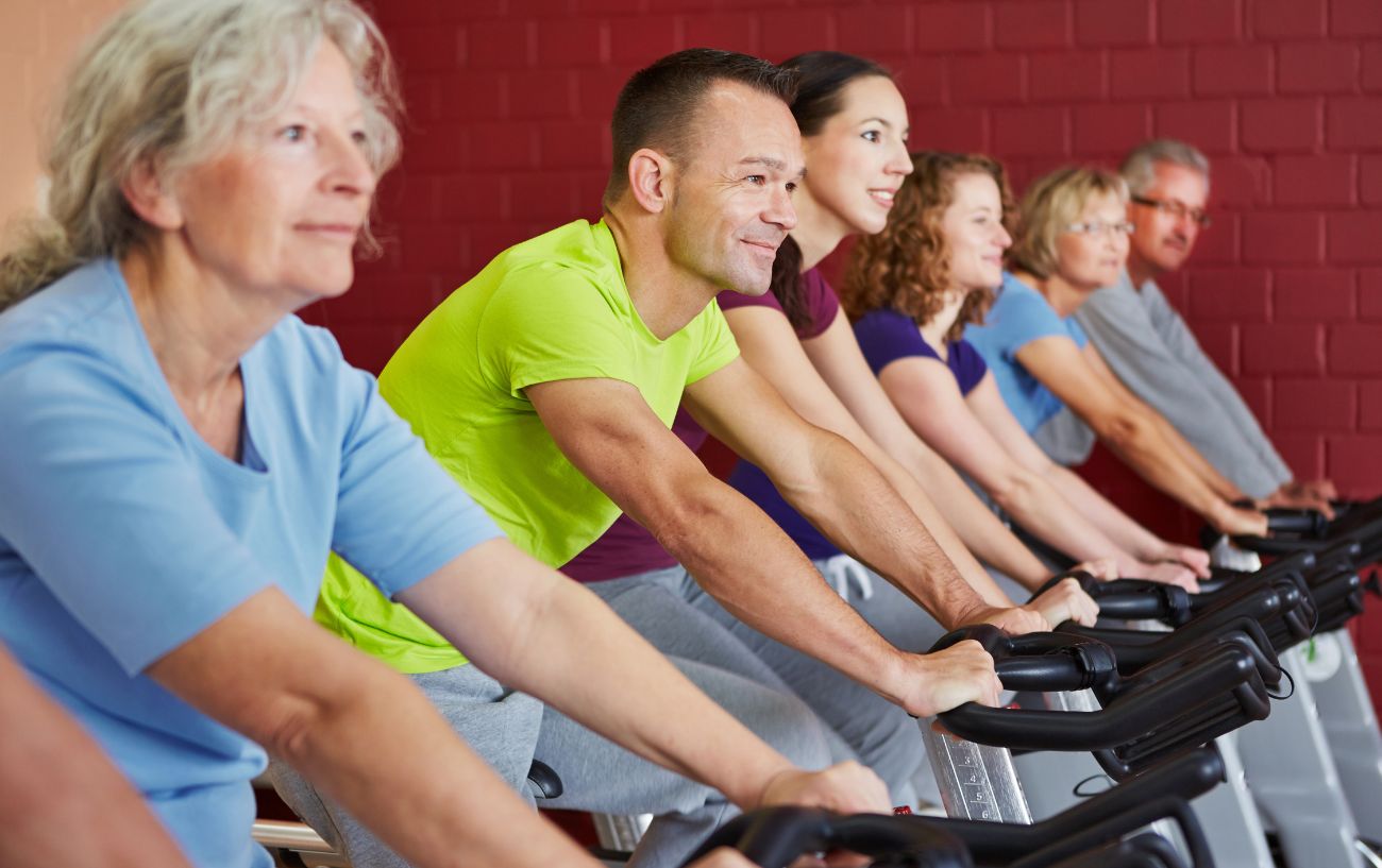 Six people begin cycling for weight loss on spin bikes.