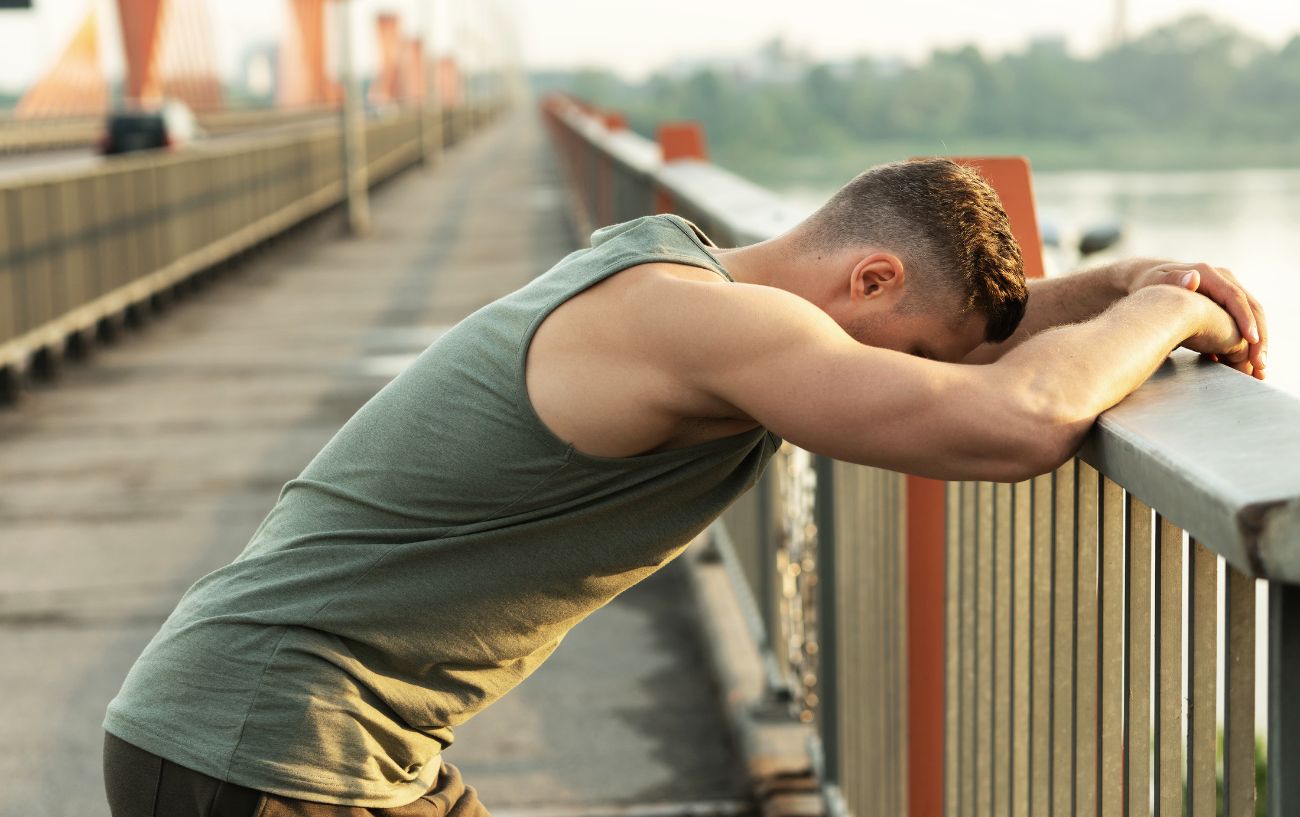A jogger on a bridge struggles to learn how to recover from overtraining syndrome.