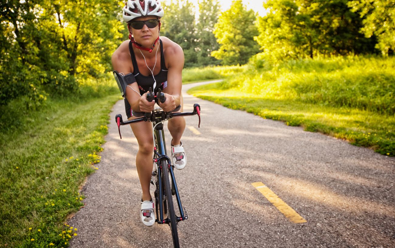 A cyclist rides a time trial bike during a duathlon.