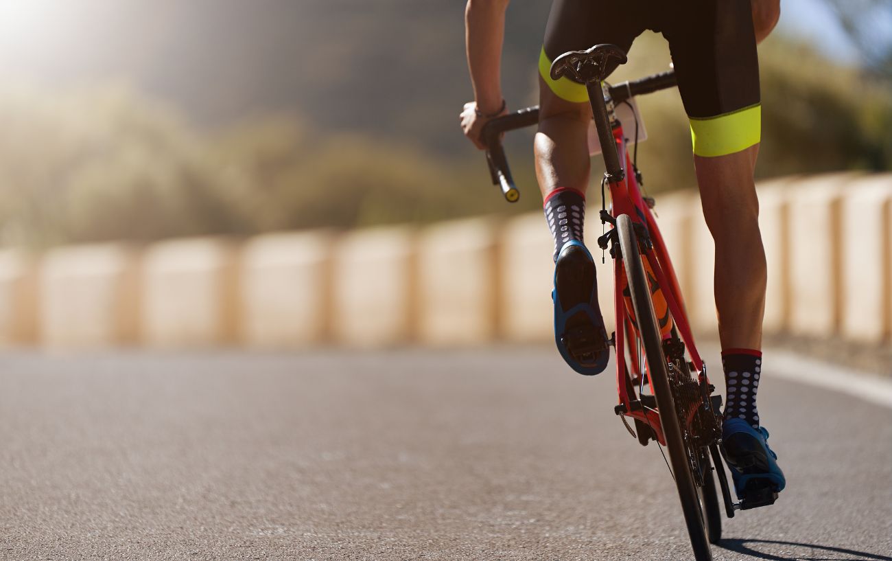 Close-up of a cyclist's leg muscles.