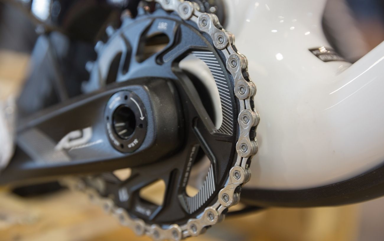 Close-up of a 1x drivetrain on a white mountain bike.