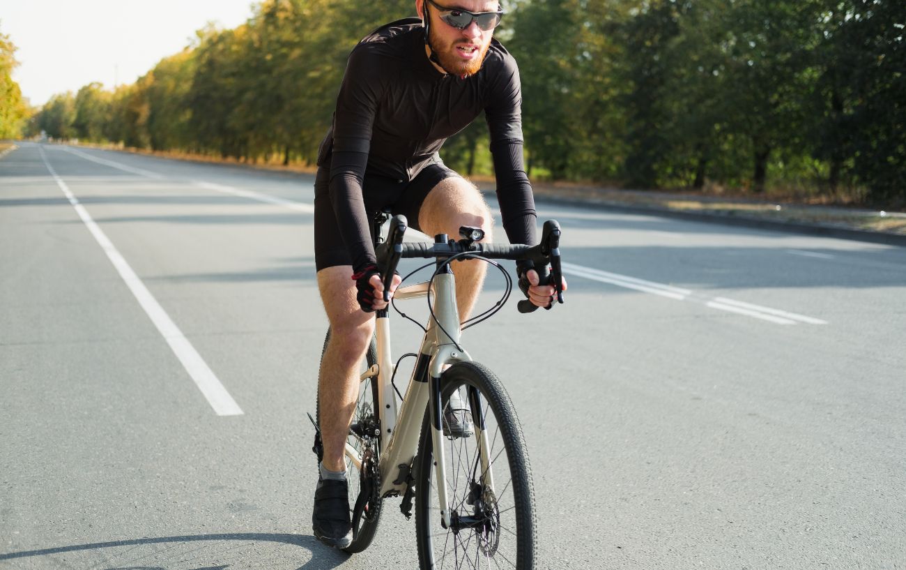 A white gravel bike on the road with 650b wheels.