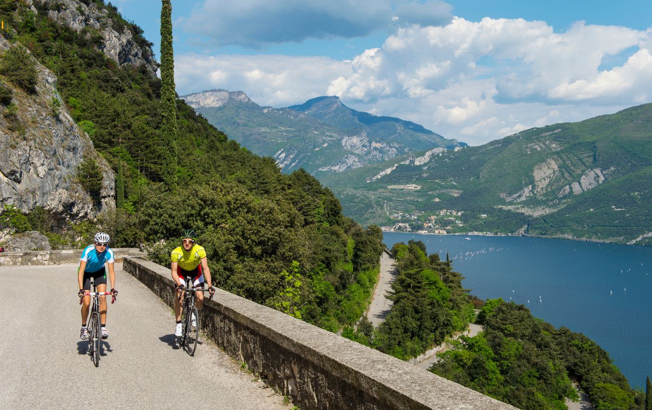 Two cyclists climb the switchbacks away from Lake Como.