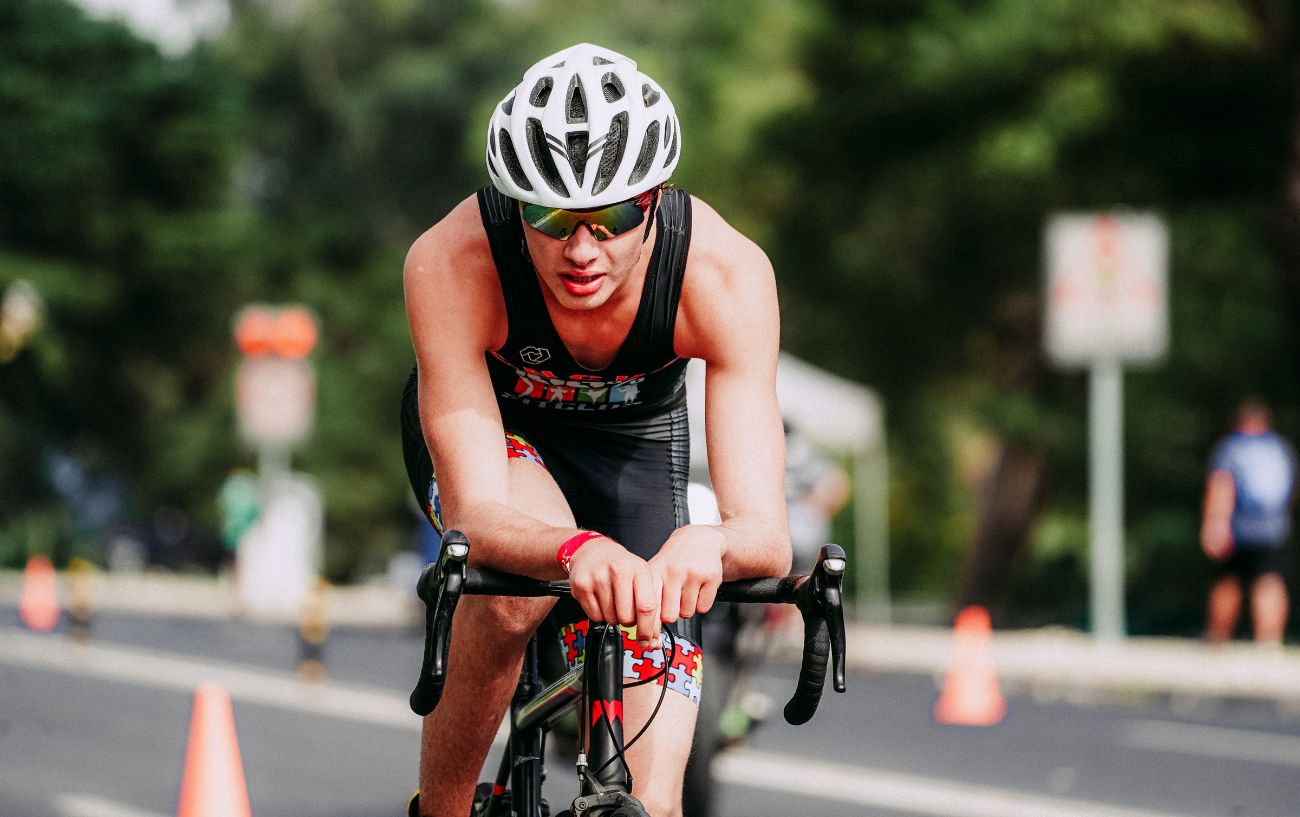 A triathlete demonstrates the Puppy Paws cycling position.