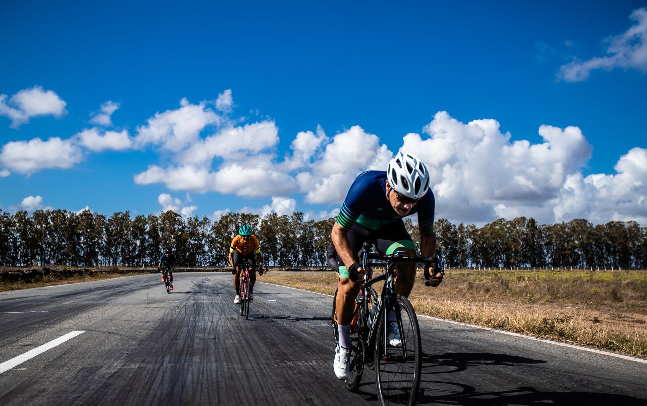 A cyclist races away from the competition at a race track.