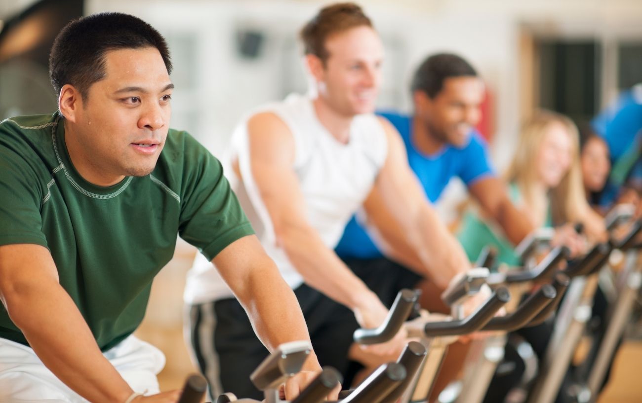 A group of cyclists during a spin class.