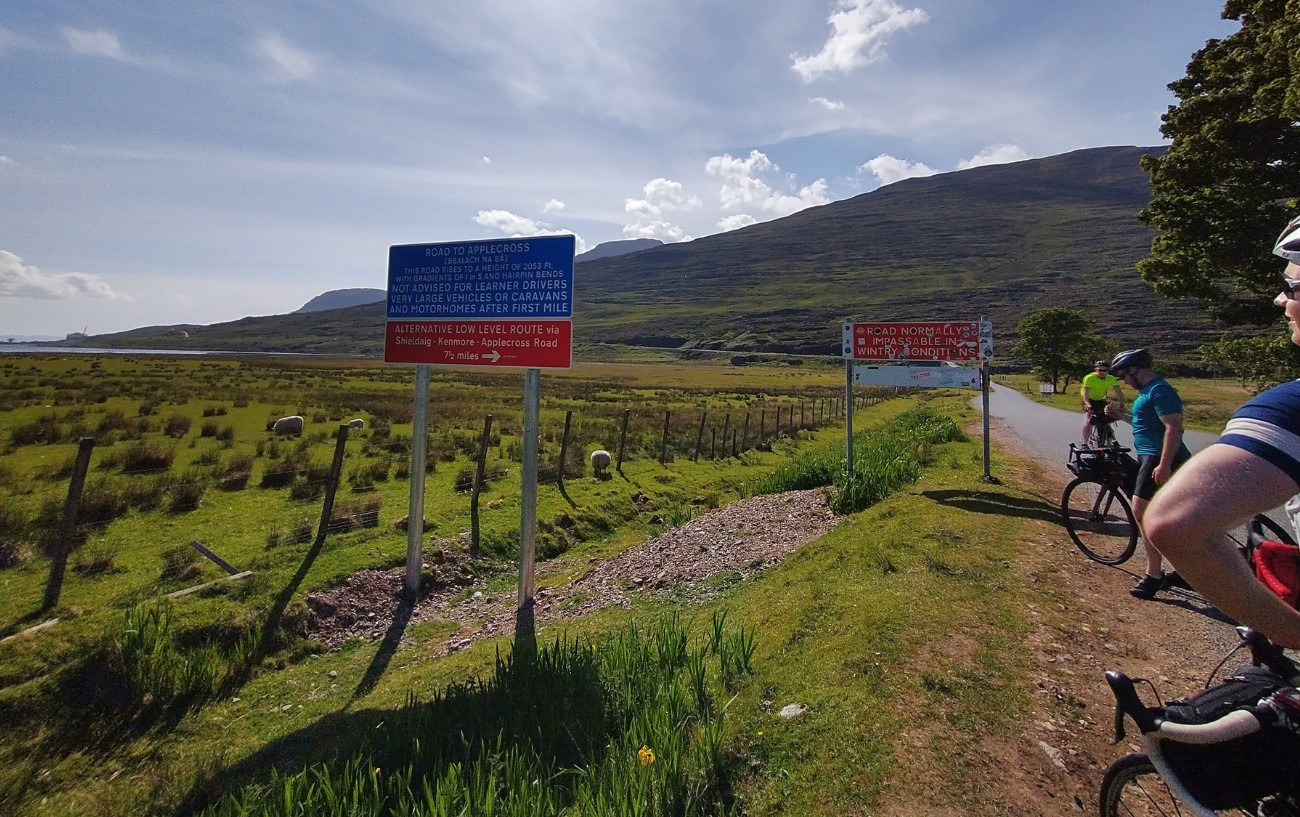 View of a sign at the bottom of the road when cycling Bealach-Na-Ba.