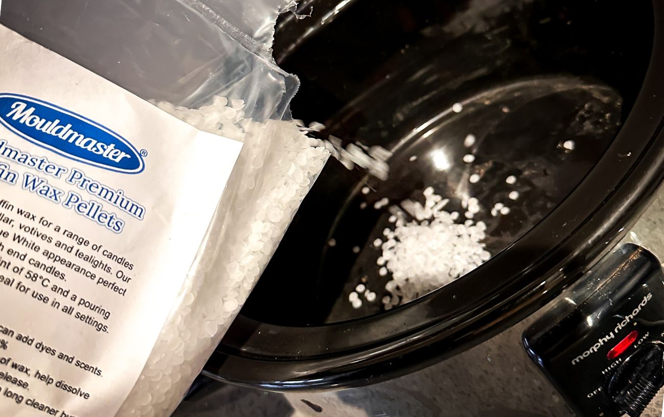 Pouring the bike chain wax into the slow cooker.