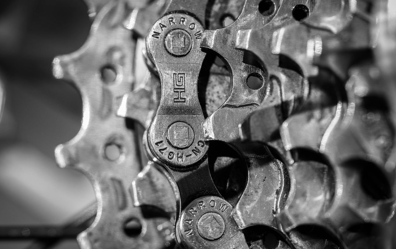 A Shimano chain in black-and-white sits on a cassette.