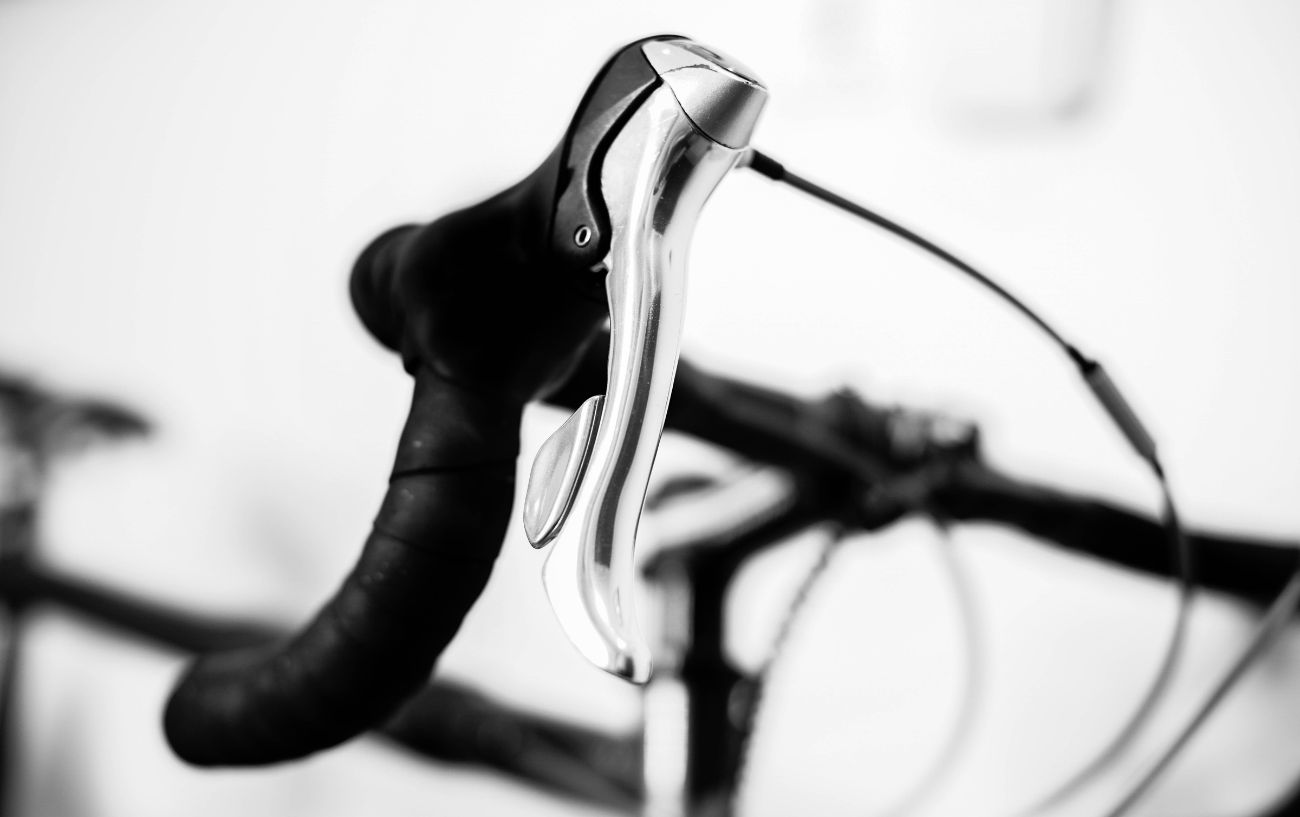The handlebars of a bike photographed in black and white.