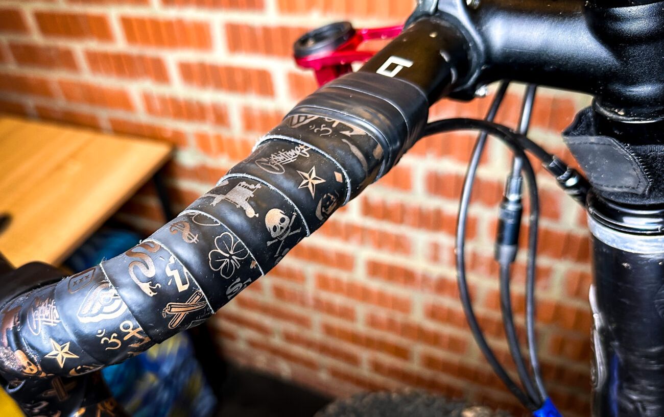 Worn bike handlebar tape ready to be removed.