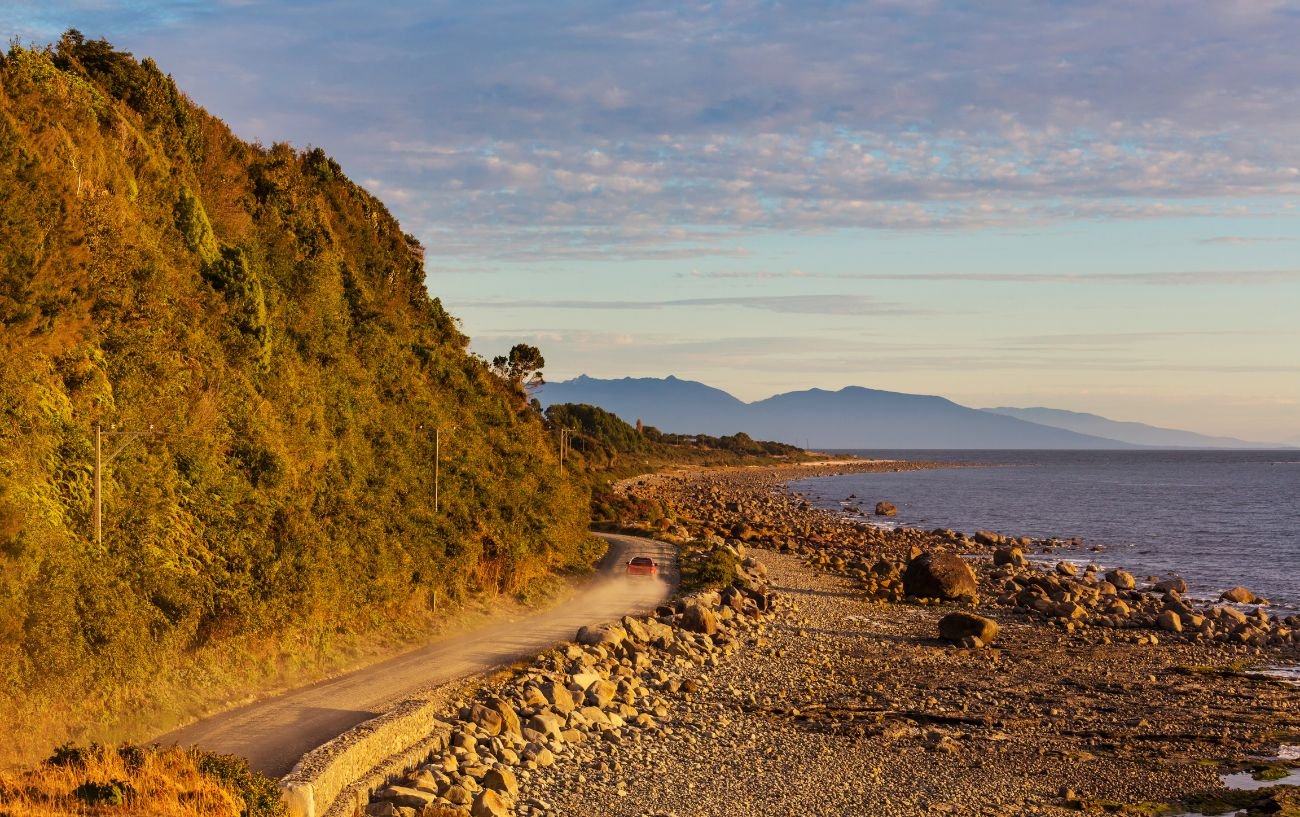 A dirt road by a lake on the Carretera Austral.