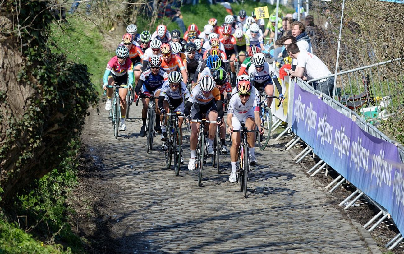 A group of cyclists race over cobblestones in one of the Spring Classics.