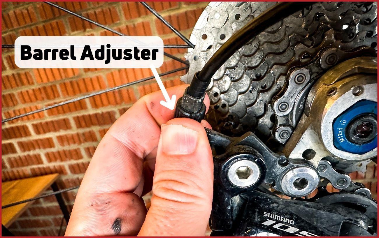 Diagram showing the barrel adjuster on the rear derailleur.
