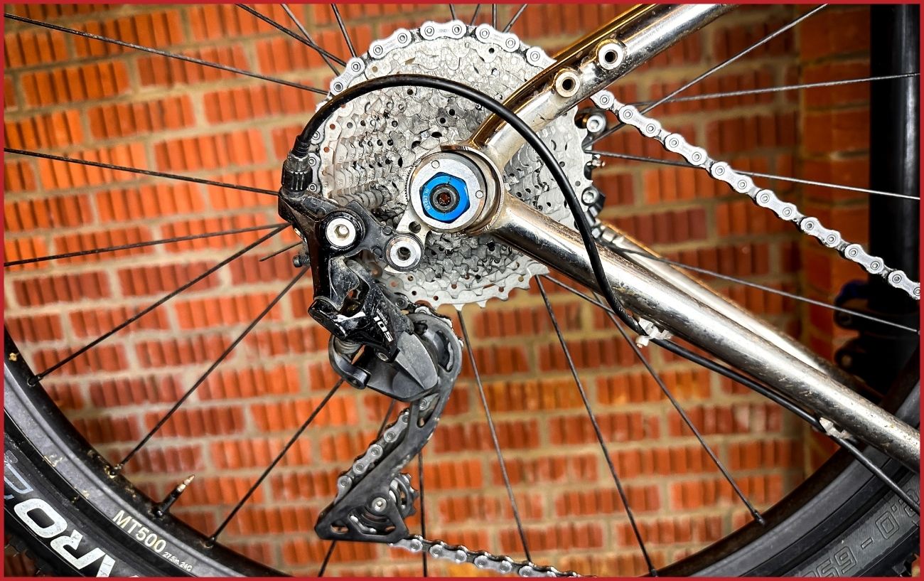 Shimano 105 rear derailleur on a silver bike frame.