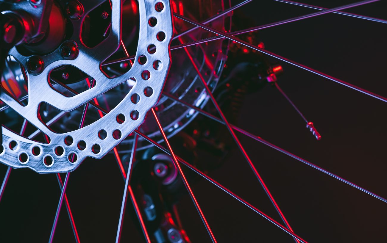A mechanical disc brake lit up with red light.