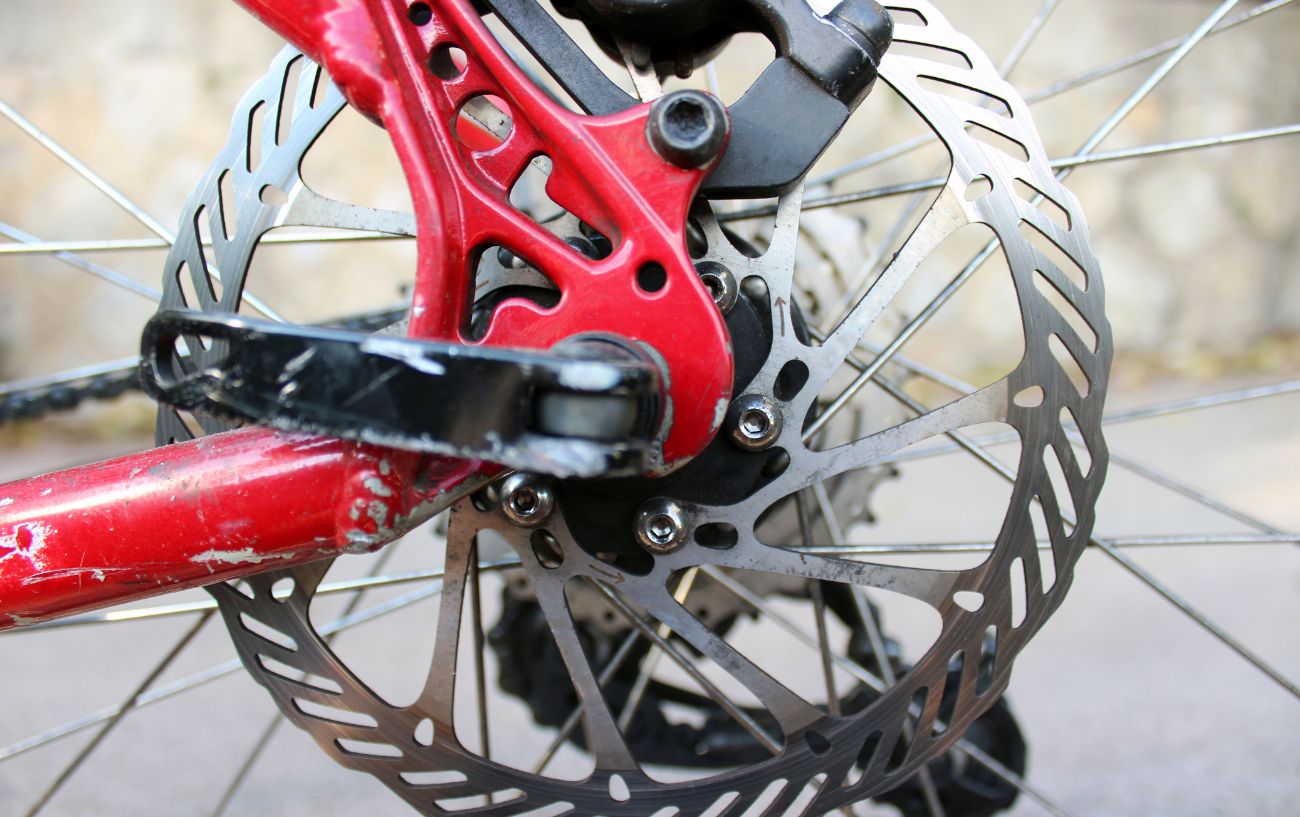 Disc brakes on a red bike frame.
