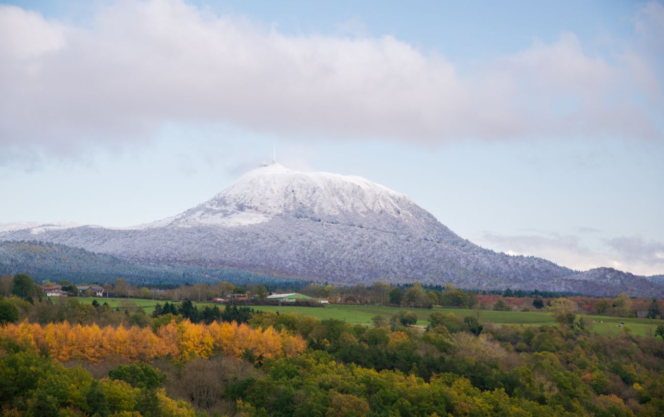 A snow-capped Puy de Dome looms over the valley below.